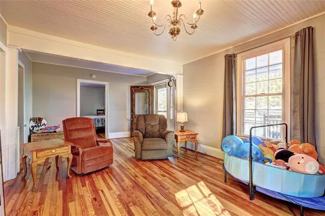 a living room with furniture and a kitchen view