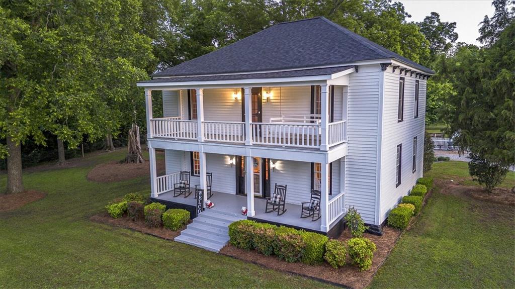 2870 Prospect Road Rutledge, GA 30663 - Photo 91 of 100 a front view of a house with a yard table and chairs
