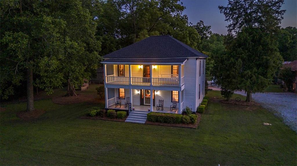 2870 Prospect Road Rutledge, GA 30663 - Photo 97 of 100 a front view of a house with a yard table and fire pit