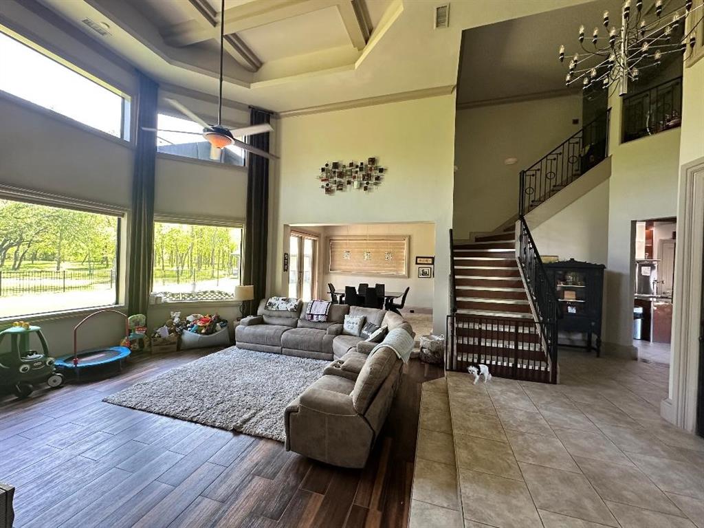 8300 Willow Circle Terrell, TX 75160 - Photo 7 of 14 Living area featuring a towering ceiling, coffered ceiling, stairway, visible vents, and ceiling fan