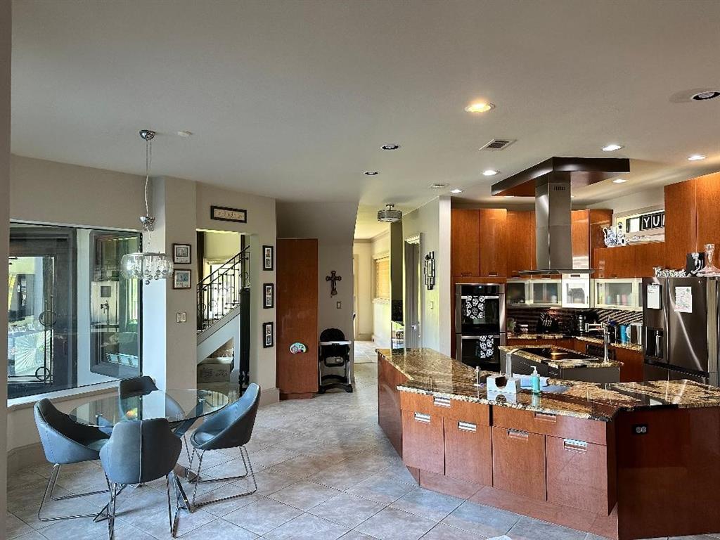 8300 Willow Circle Terrell, TX 75160 - Photo 8 of 14 Kitchen featuring visible vents, appliances with stainless steel finishes, island exhaust hood, dark stone counters, and a spacious island