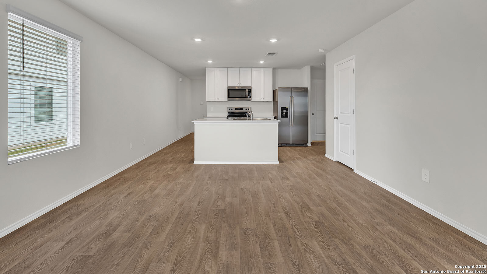 400 Wild Goose Drive Luling, TX 78648 - Photo 14 of 28 a view of a kitchen with kitchen island stainless steel appliances wooden floor and window
