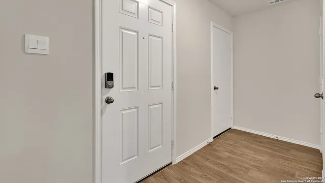 a view of a hallway with wooden floor