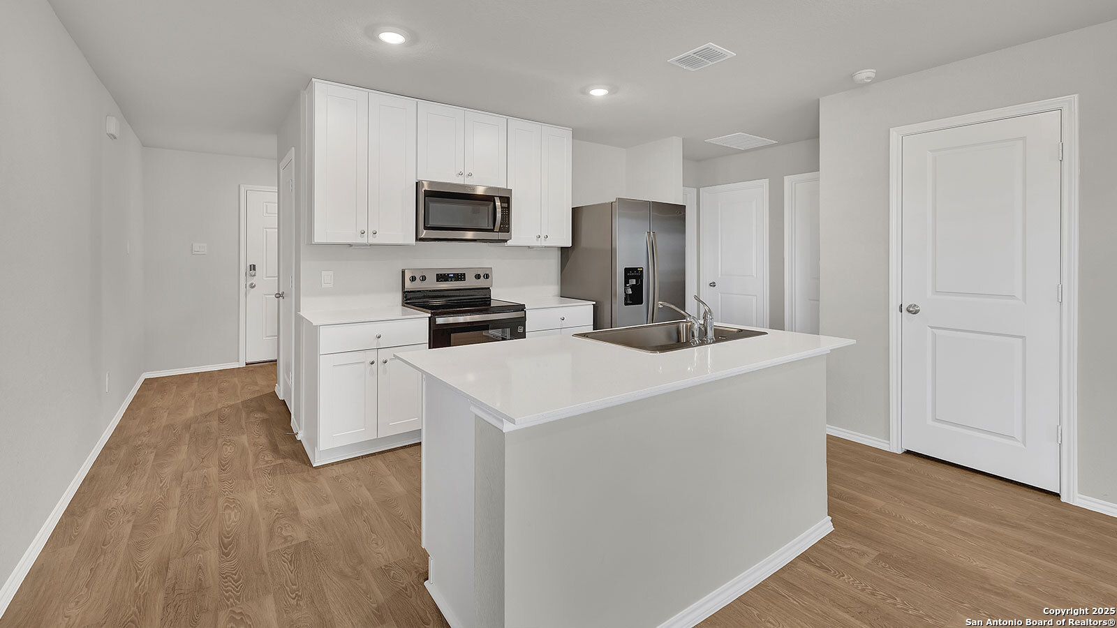 400 Wild Goose Drive Luling, TX 78648 - Photo 7 of 28 a kitchen with stainless steel appliances a microwave a sink and a refrigerator