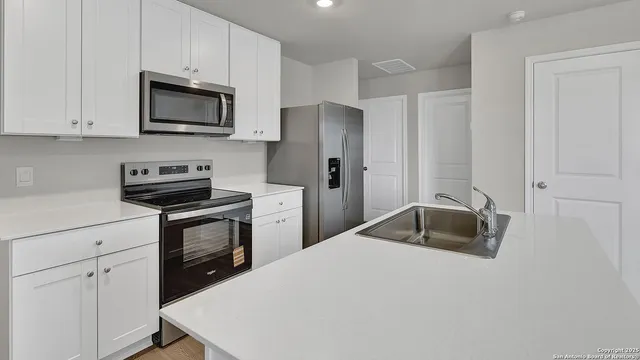 a kitchen with a sink and cabinets