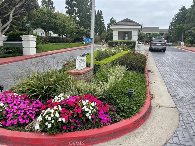 a view of a house with a garden and pathway