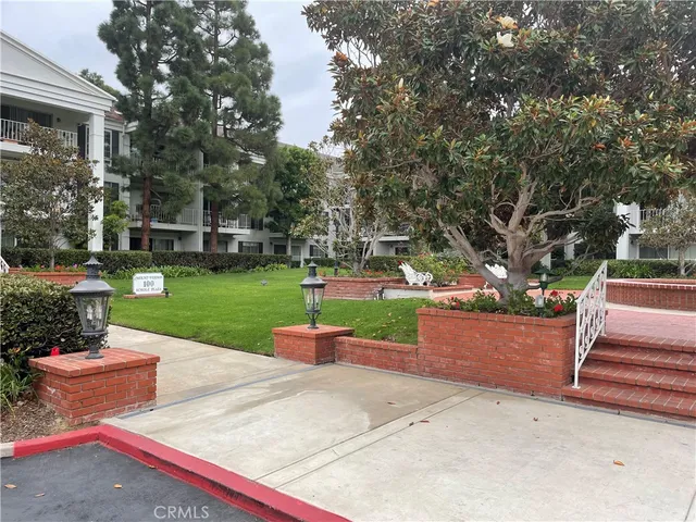 a view of a house with a yard and sitting area