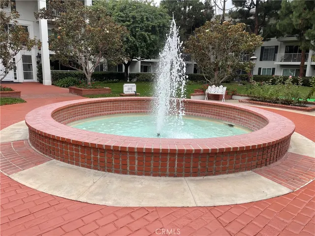 a view of a yard with plants and trees