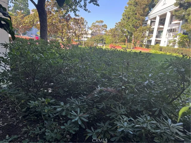 a view of a patio with iron fence