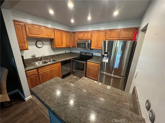a bathroom with a granite countertop sink and washing machine