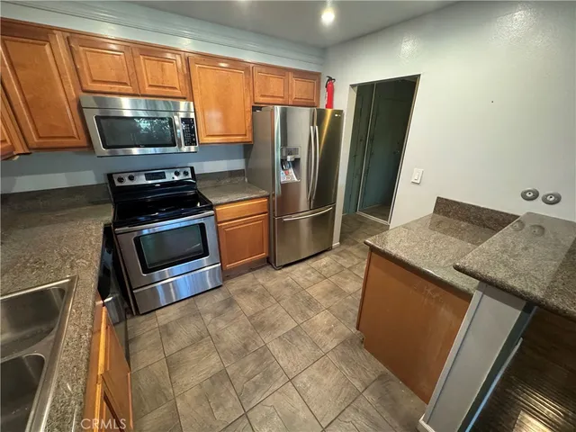a bathroom with a granite countertop shower and a sink