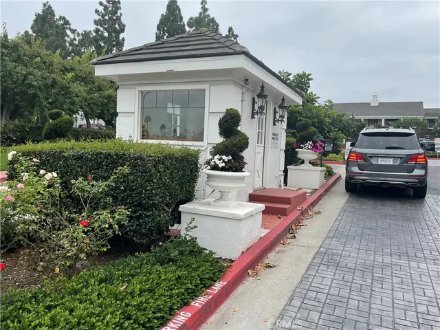 a view of a white house with a fountain and a fountain