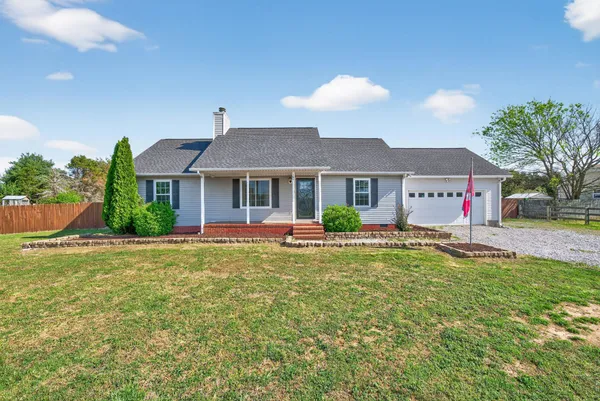 a front view of a house with swimming pool having outdoor seating