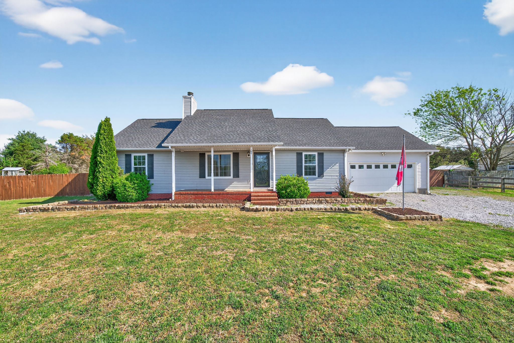 a front view of a house with swimming pool having outdoor seating