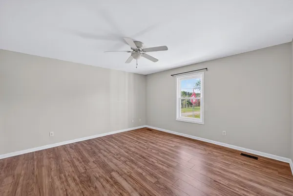 wooden floor in an empty room with a window
