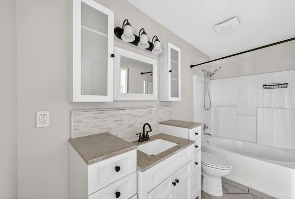 a bathroom with a sink toilet and shower