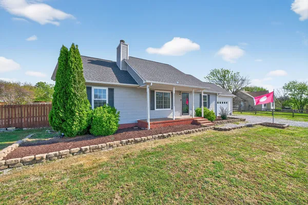 a view of a house with a yard and sitting area