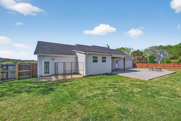 a view of a house with a yard and sitting area