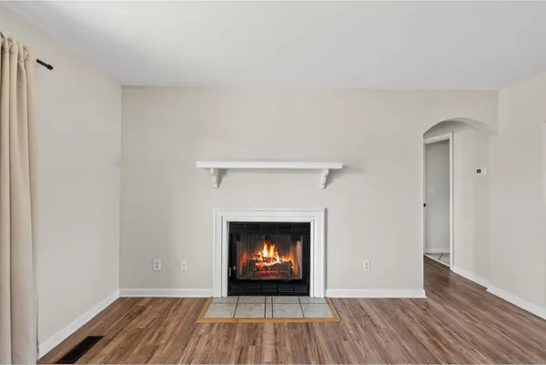 a room with a fireplace and wooden floor