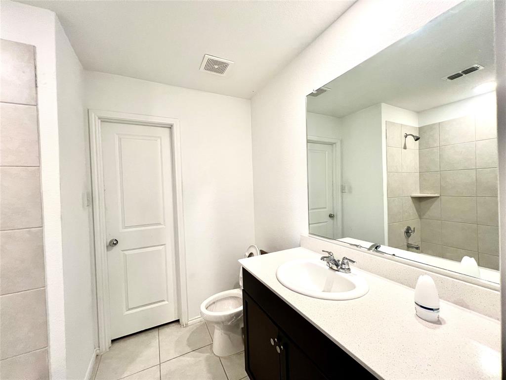 5711 Bristle Leaf Drive Princeton, TX 75407 - Photo 11 of 23 a bathroom with a sink toilet and shower