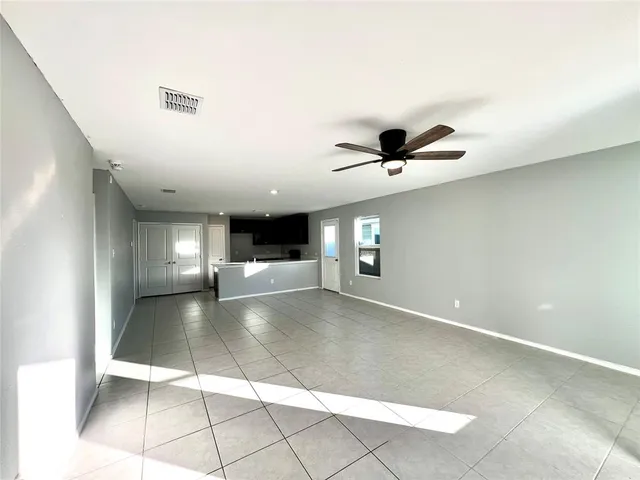 a view of a livingroom with a ceiling fan and window