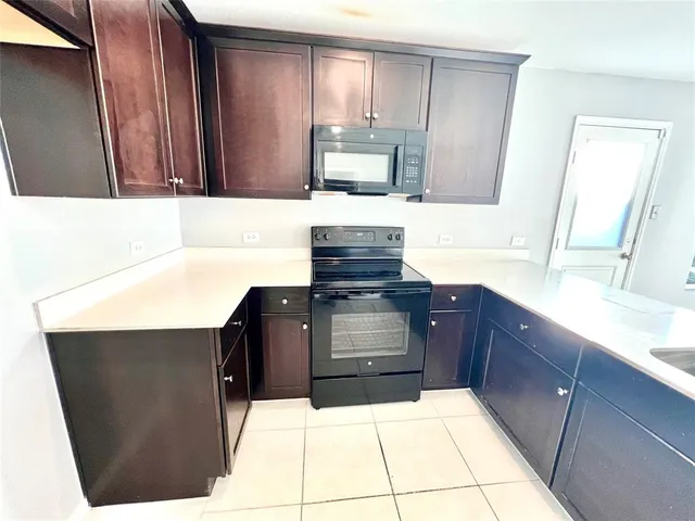 a kitchen with a refrigerator and a sink
