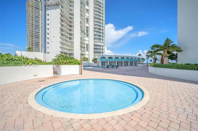 a living room with furniture a rug and a large window