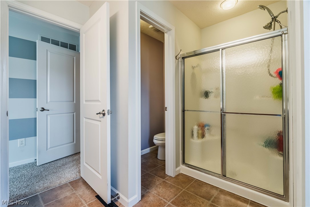 6687 List Street Northwest Canton, OH 44708 - Photo 18 of 21 Full bath with a stall shower and dark colored carpet