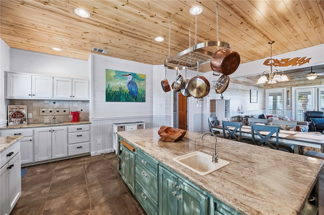 70 Copano Ridge Road Rockport, TX 78382 - Photo 11 of 40 a kitchen with stove a sink and cabinets