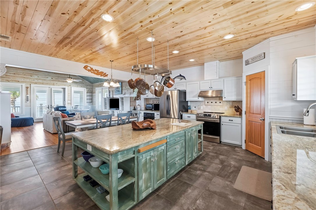 70 Copano Ridge Road Rockport, TX 78382 - Photo 12 of 40 a large kitchen with stainless steel appliances lots of counter space and breakfast area