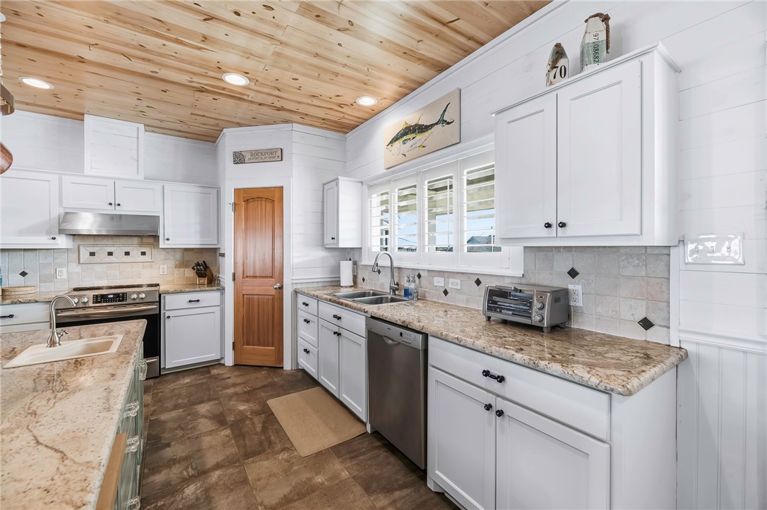 70 Copano Ridge Road Rockport, TX 78382 - Photo 13 of 40 a kitchen with granite countertop cabinets stainless steel appliances and a counter space