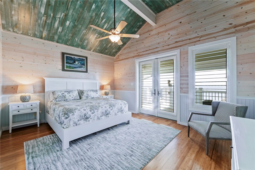 70 Copano Ridge Road Rockport, TX 78382 - Photo 14 of 40 a bedroom with a bed and a couch