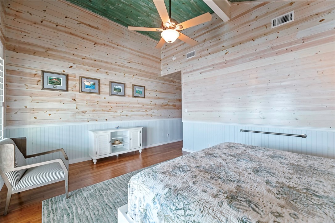 70 Copano Ridge Road Rockport, TX 78382 - Photo 17 of 40 a bedroom with a bed and a dresser