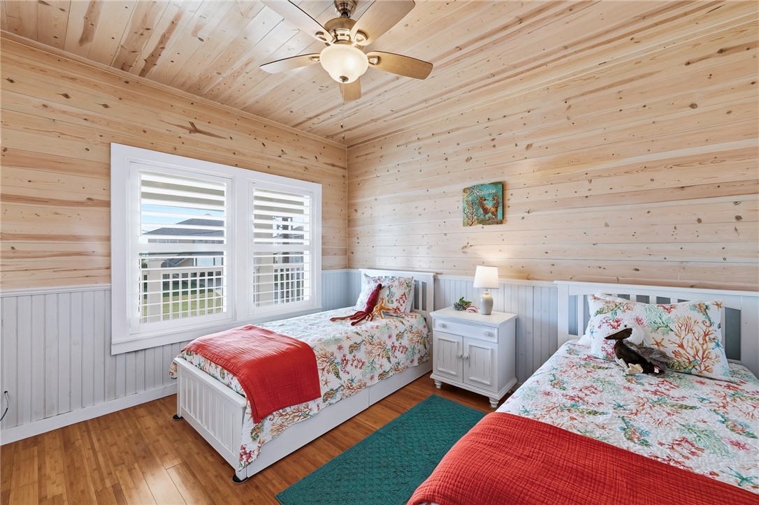 70 Copano Ridge Road Rockport, TX 78382 - Photo 22 of 40 a bedroom with two large bed and a window