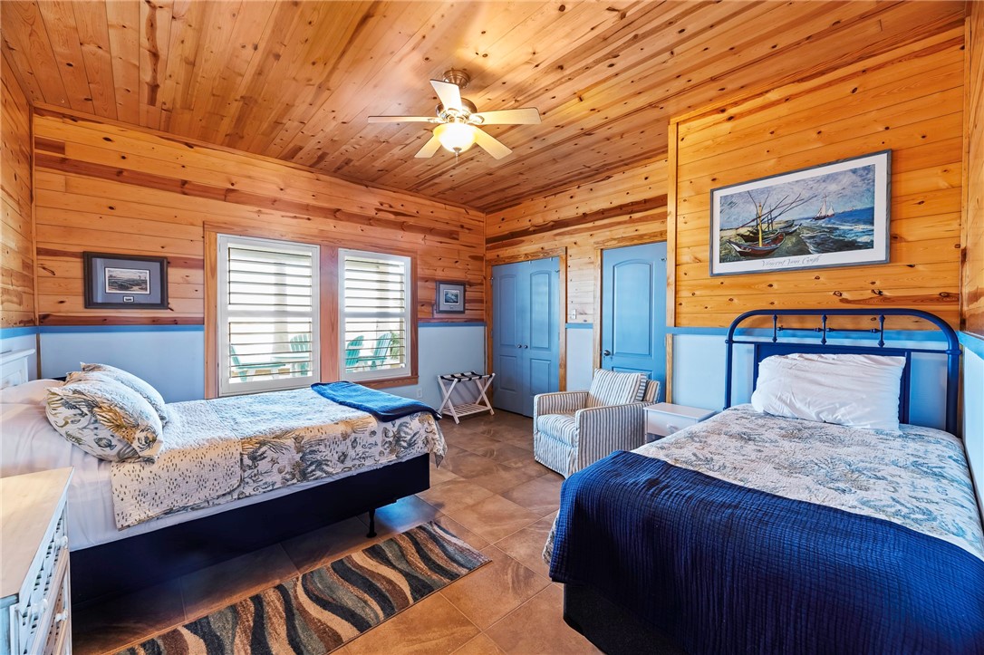 70 Copano Ridge Road Rockport, TX 78382 - Photo 29 of 40 a bedroom with double bed and a large window