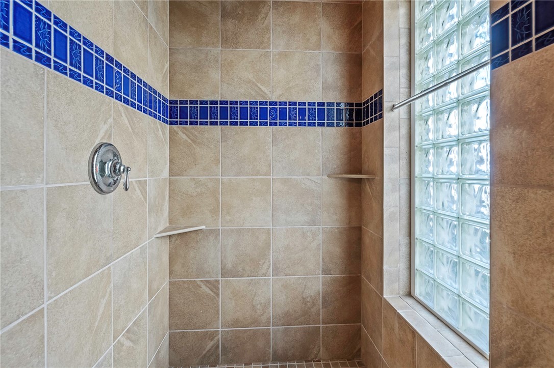 70 Copano Ridge Road Rockport, TX 78382 - Photo 31 of 40 a bathroom with a shower and a window