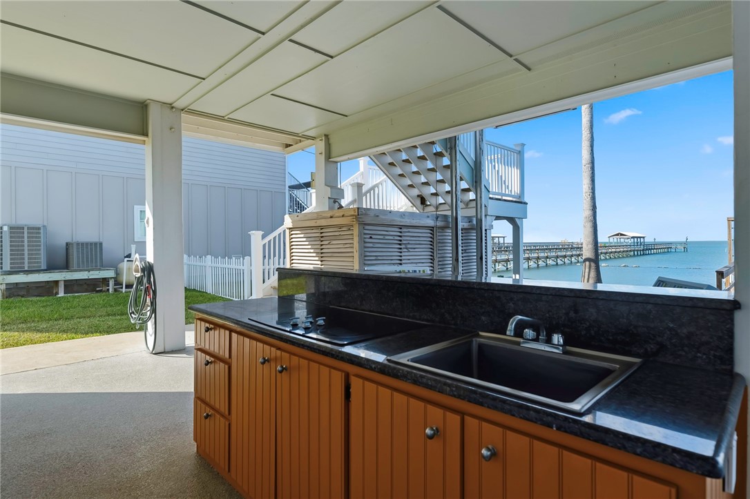 70 Copano Ridge Road Rockport, TX 78382 - Photo 32 of 40 a kitchen with a sink and a refrigerator