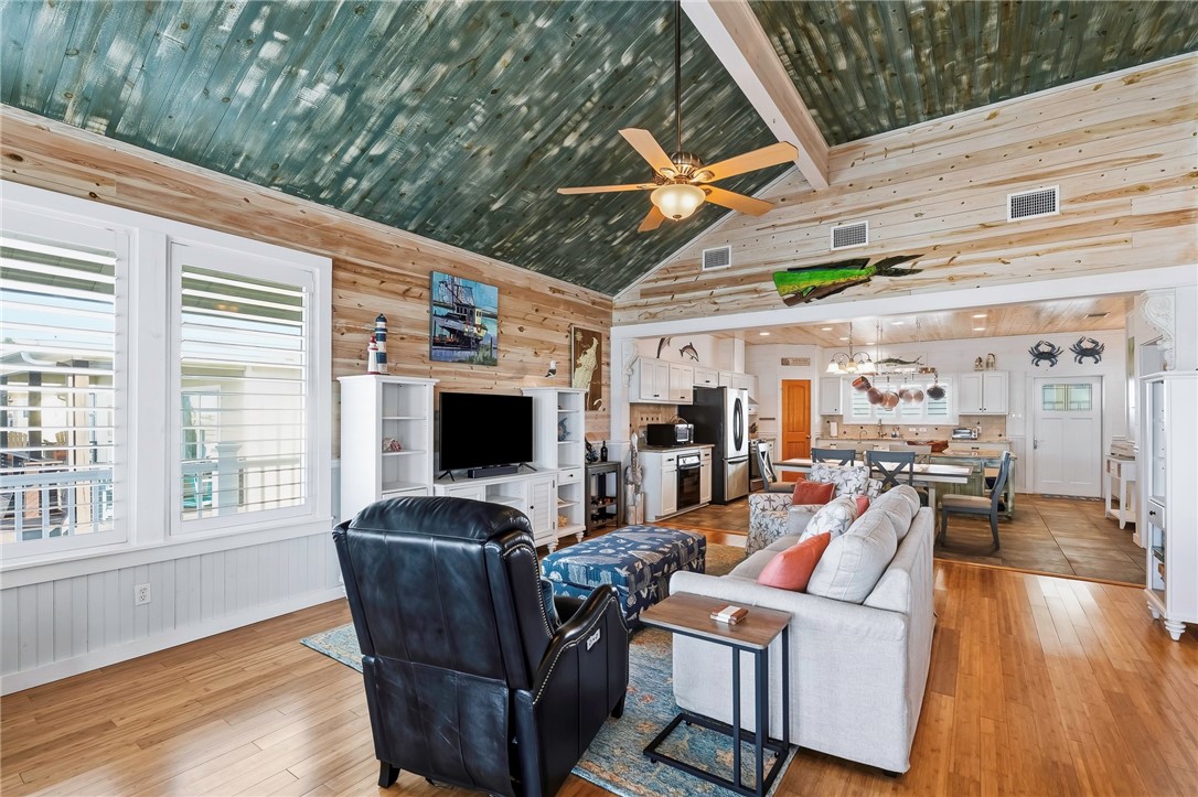 70 Copano Ridge Road Rockport, TX 78382 - Photo 5 of 40 a living room with furniture a flat screen tv and floor to ceiling window