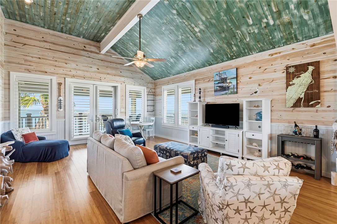 70 Copano Ridge Road Rockport, TX 78382 - Photo 7 of 40 a living room with furniture a flat screen tv and a fireplace