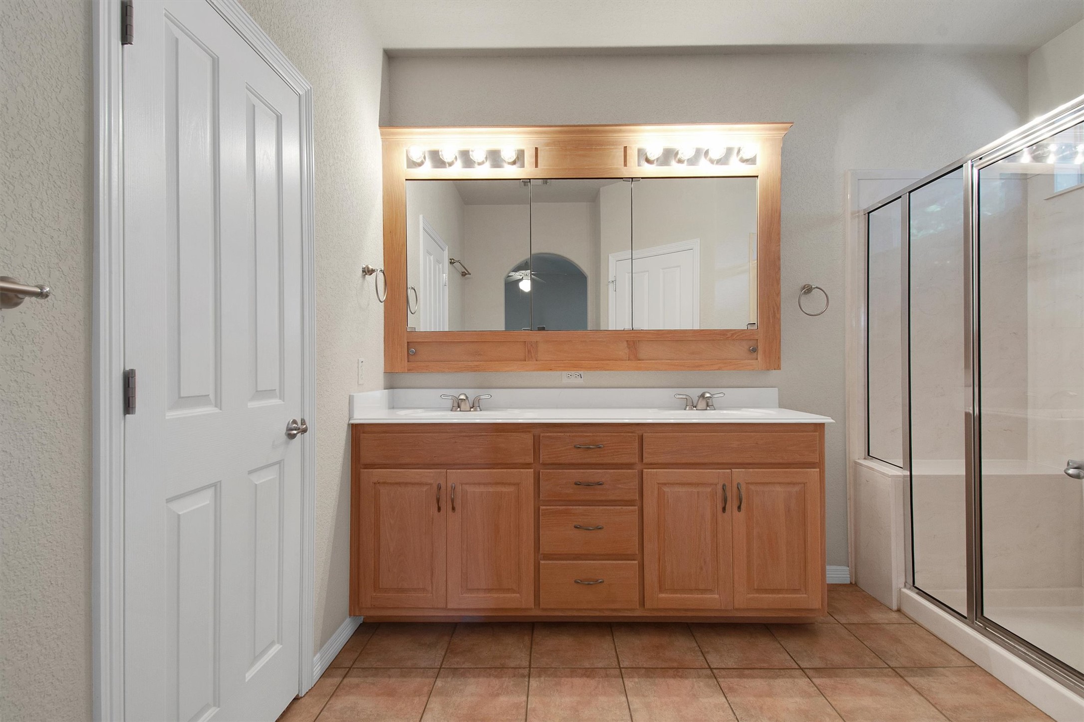 102 Lavaca Lane Georgetown, TX 78628 - Photo 20 of 30 Primary bathroom with walk-in shower and dual vanity, walk-in closet is accessed from door on the left