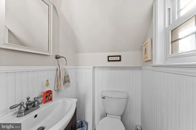 a bedroom with a bed and a refrigerator