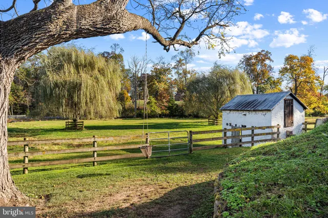 an aerial view of a house with swimming pool and porch with furniture