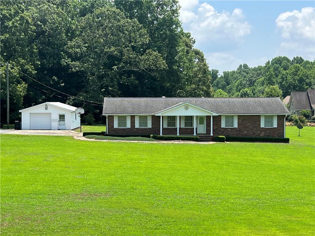 4745 Watson Road Cumming, GA 30028 - Photo 1 of 1 a front view of a house with garden