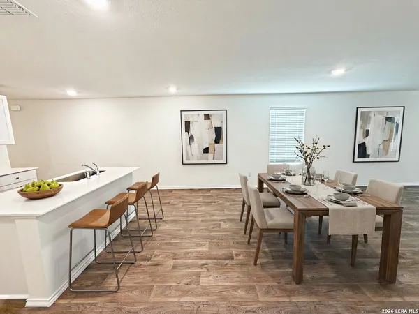 a view of a room with wooden floor and window