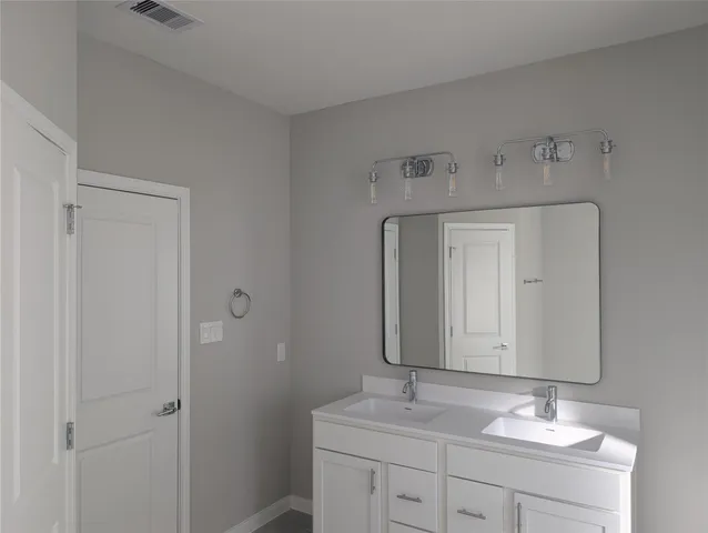 a bathroom with a sink vanity granite and a mirror