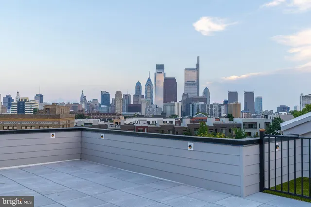 a view of a roof deck with furniture