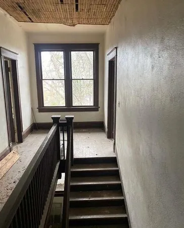 a view of entryway with wooden floor and a window
