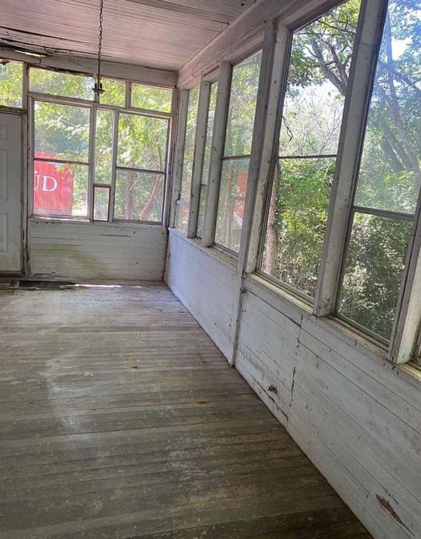 114 East Adams Street Sparta, GA 31087 - Photo 3 of 17 a view of an empty room with a window