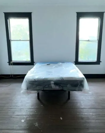 a room with a bed and a window