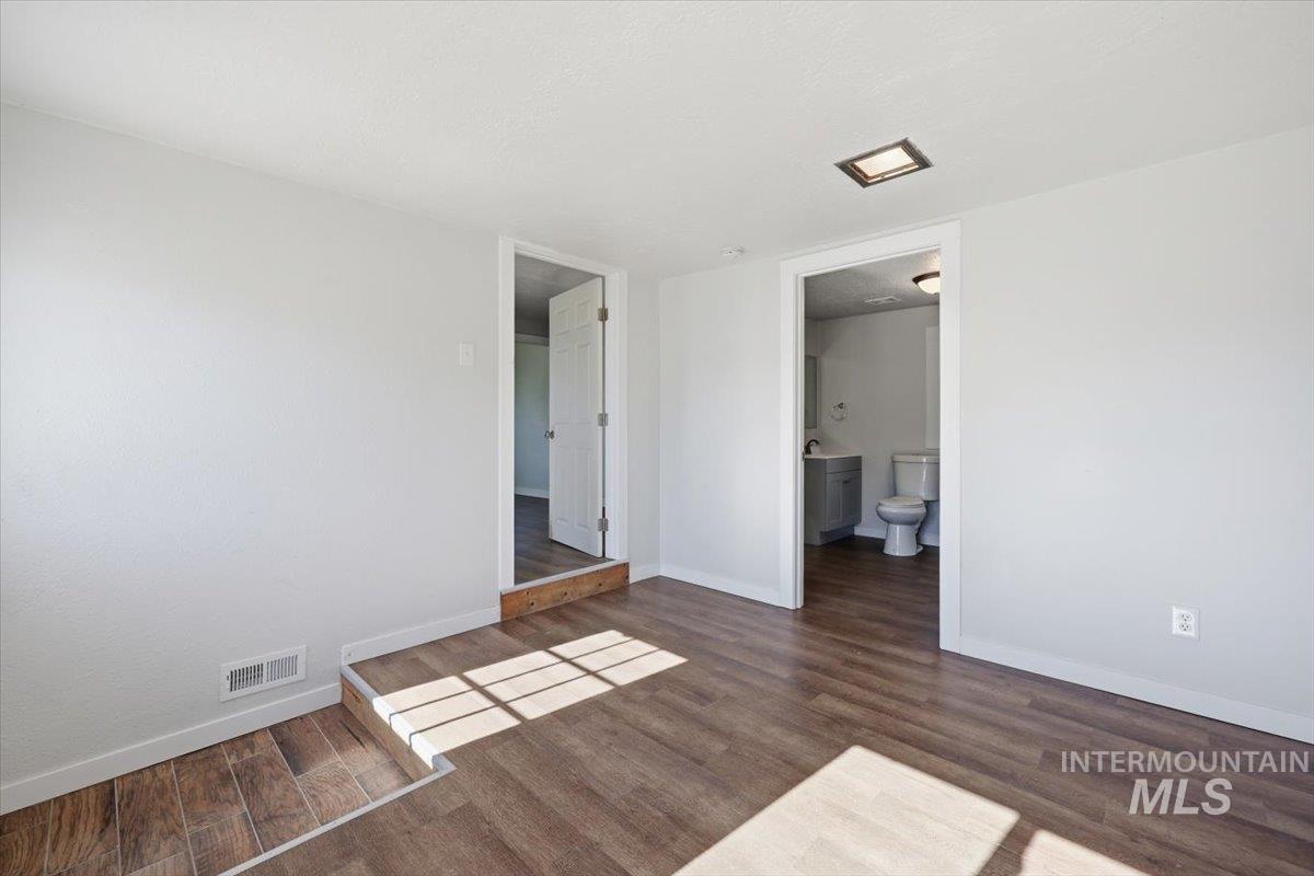 956 Southeast Hamilton Road Mountain Home, ID 83647 - Photo 18 of 34 Interior space with light gray walls and wood-finish flooring